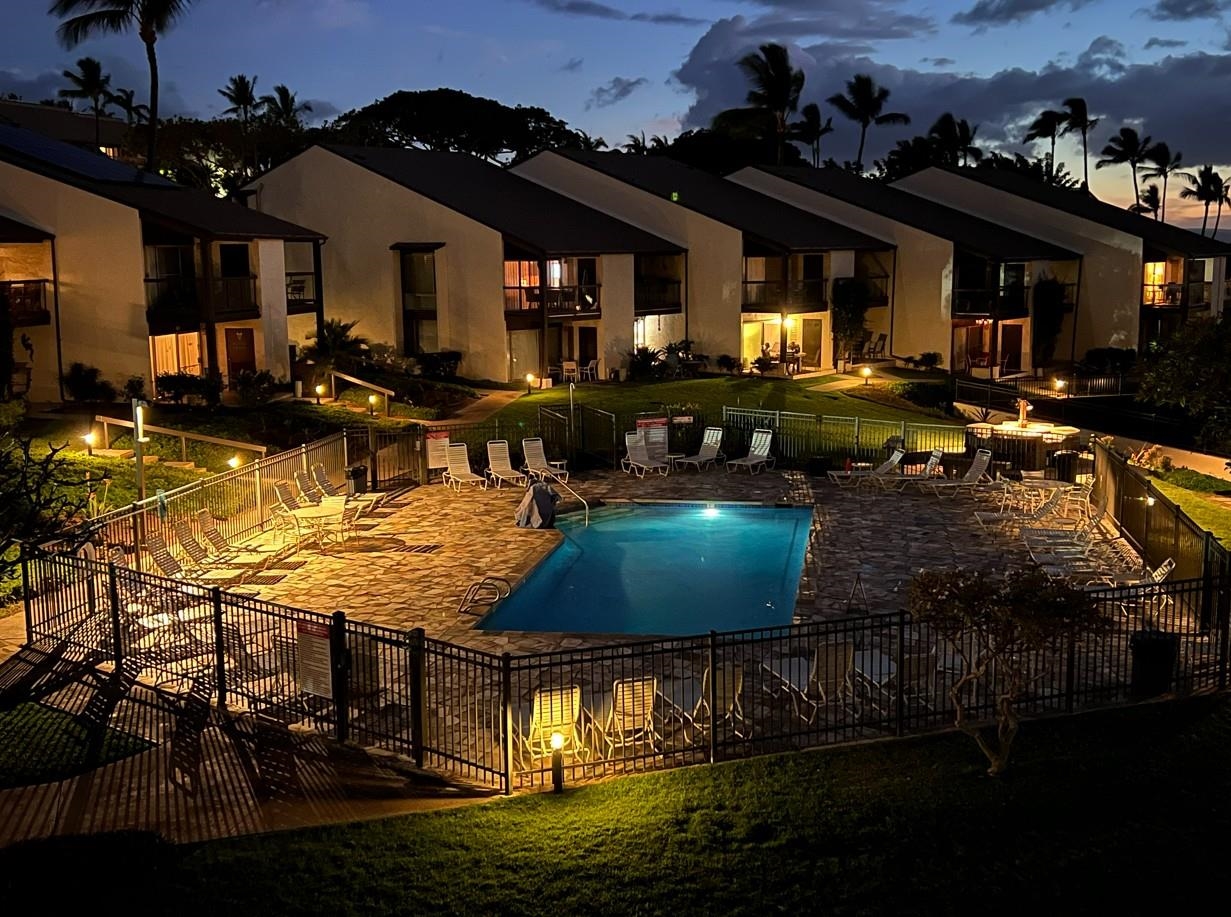 2737 South Kihei Road, Unit 336 Kihei, HI 96753 - Photo 14 of 38 a view of a swimming pool with tables and chairs under an umbrella
