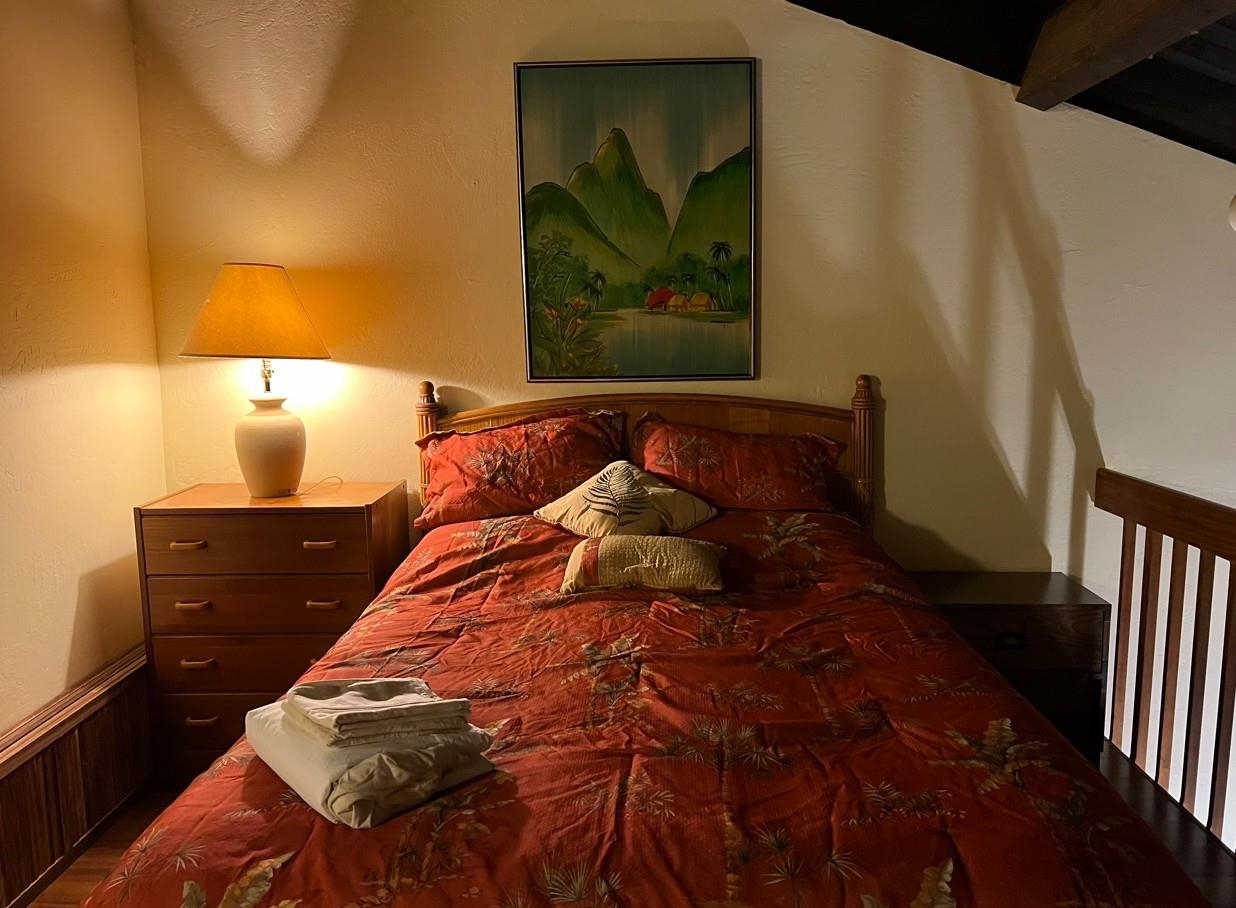 2737 South Kihei Road, Unit 336 Kihei, HI 96753 - Photo 22 of 38 a bedroom with a bed and painting on the wall