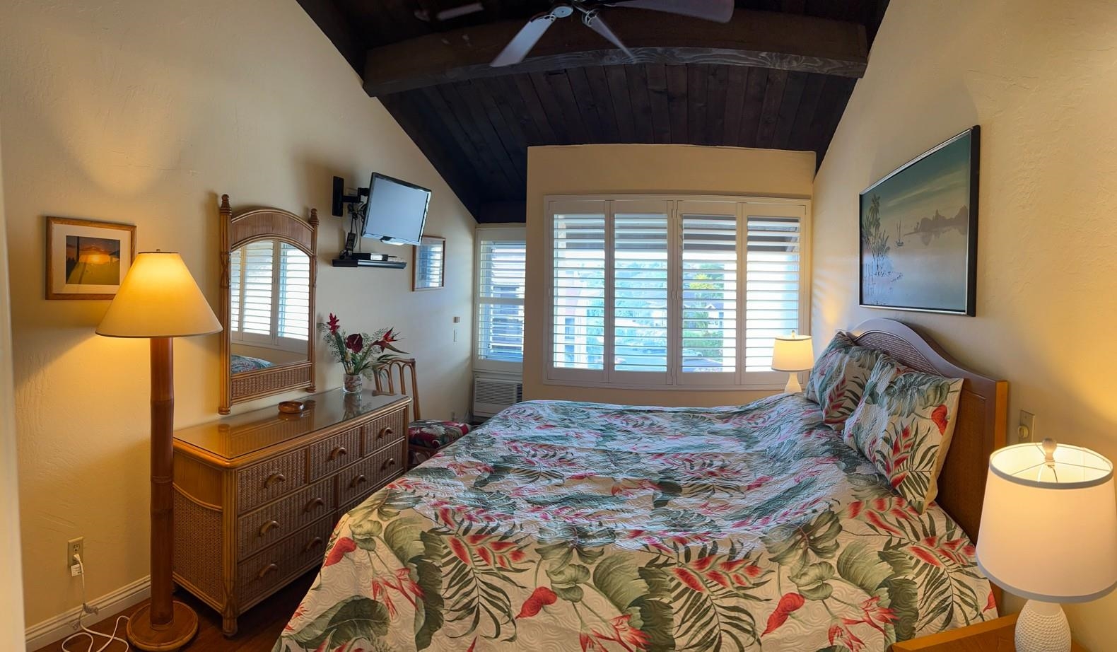 2737 South Kihei Road, Unit 336 Kihei, HI 96753 - Photo 24 of 38 a bedroom with a bed a table and painting on the wall