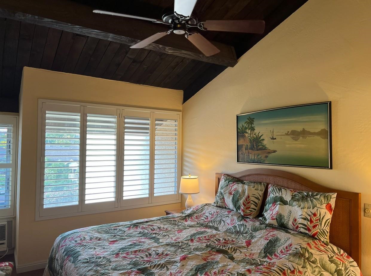 2737 South Kihei Road, Unit 336 Kihei, HI 96753 - Photo 25 of 38 a bedroom with a bed and a painting on the wall