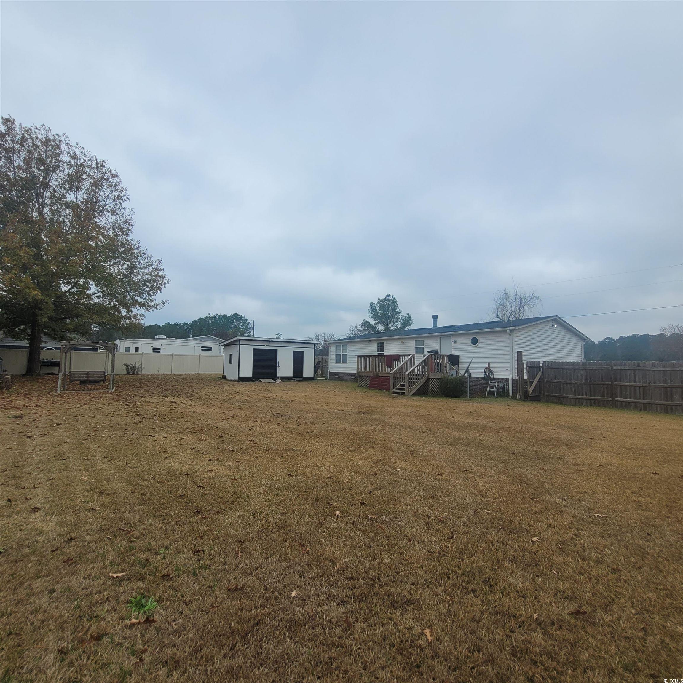 1781 Dixie Court Loris, SC 29569 - Photo 17 of 18 Fenced backyard featuring an outbuilding and stairway