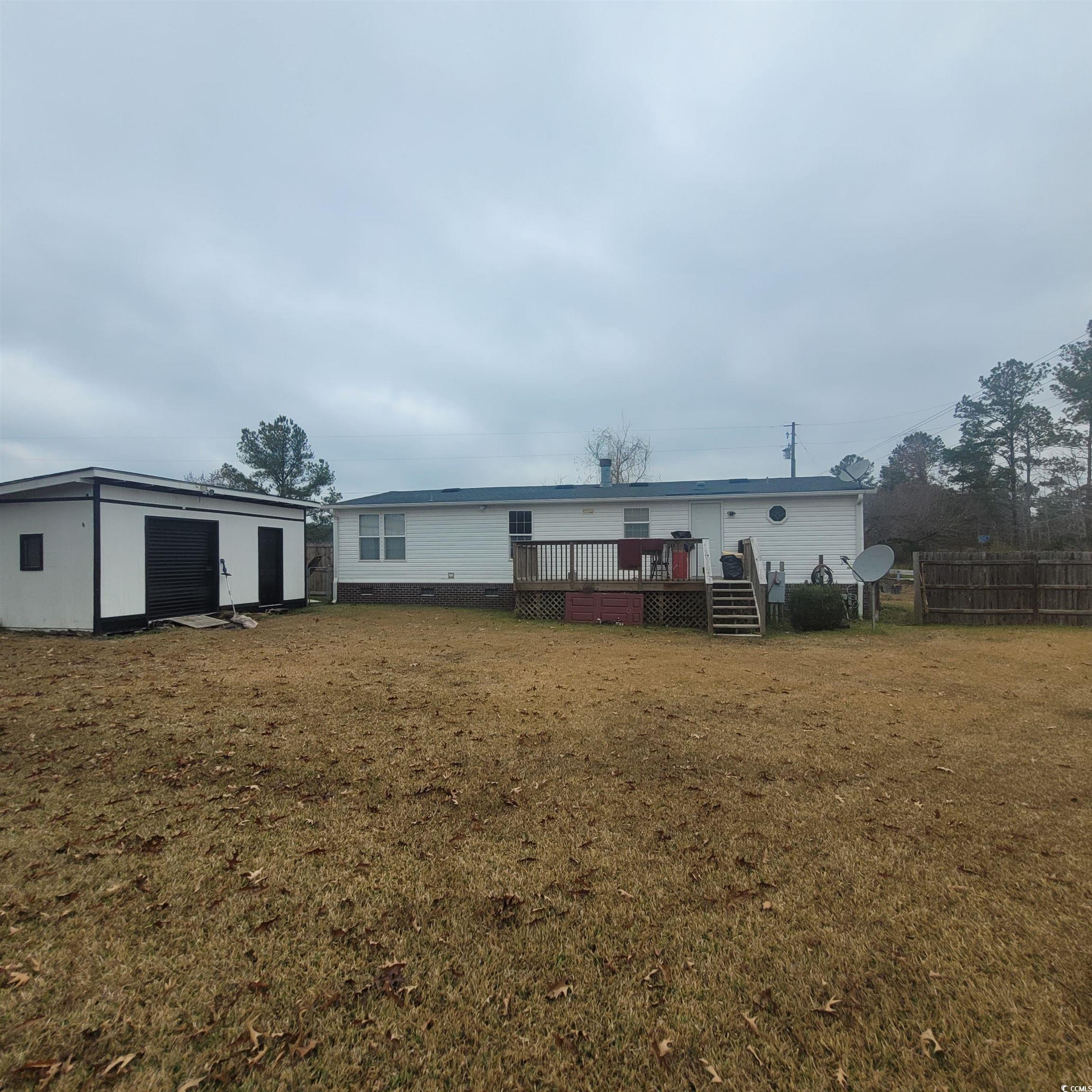 1781 Dixie Court Loris, SC 29569 - Photo 18 of 18 Back of house featuring a deck, an outbuilding, and a garage