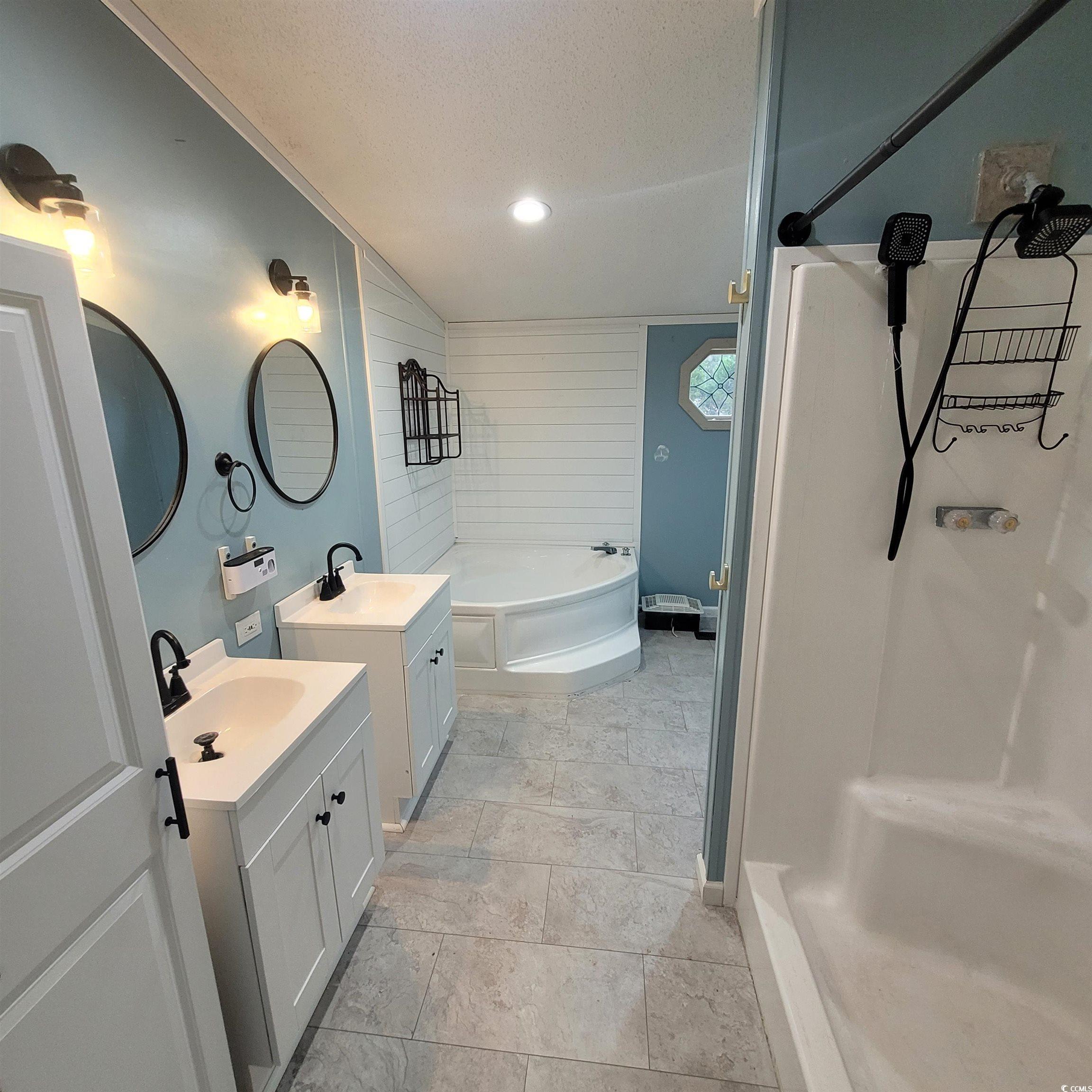 1781 Dixie Court Loris, SC 29569 - Photo 6 of 18 Full bathroom with two vanities, a textured ceiling, a shower, and a bathtub