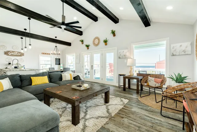 a living room with lots of furniture and a large window