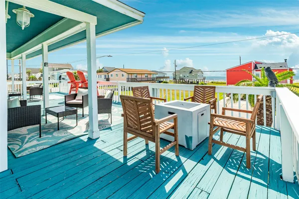 a view of a chairs and table in the balcony