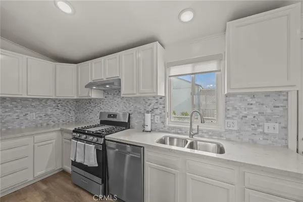 a kitchen that has a sink and cabinets