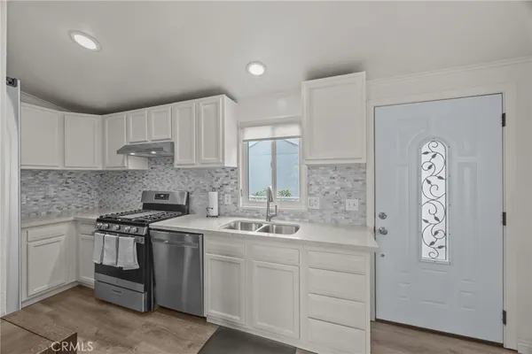 a kitchen with a sink stove and cabinets