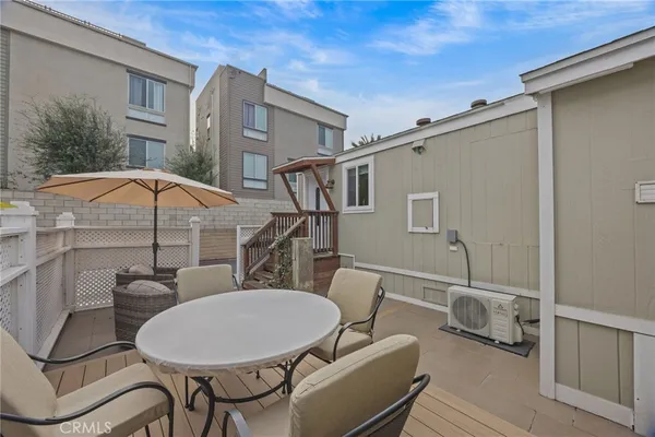 a backyard of a house with table and chairs