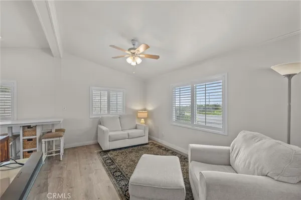 a living room with furniture a bed and a window