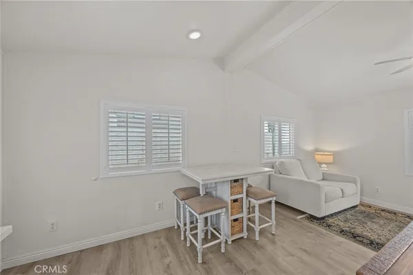 a dining room with a wooden table and chairs