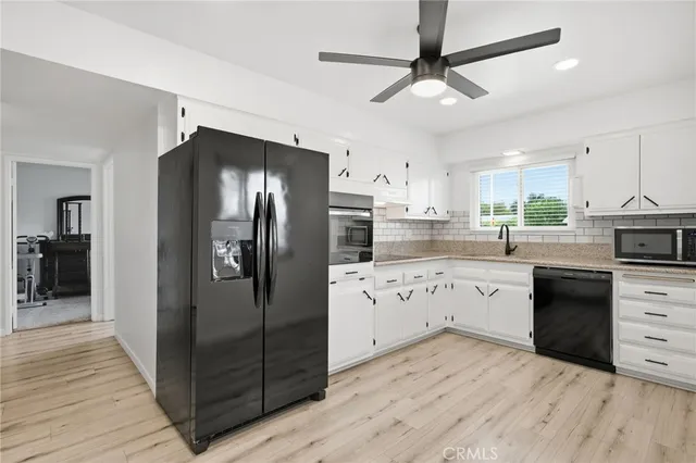 a kitchen with granite countertop a refrigerator and a sink