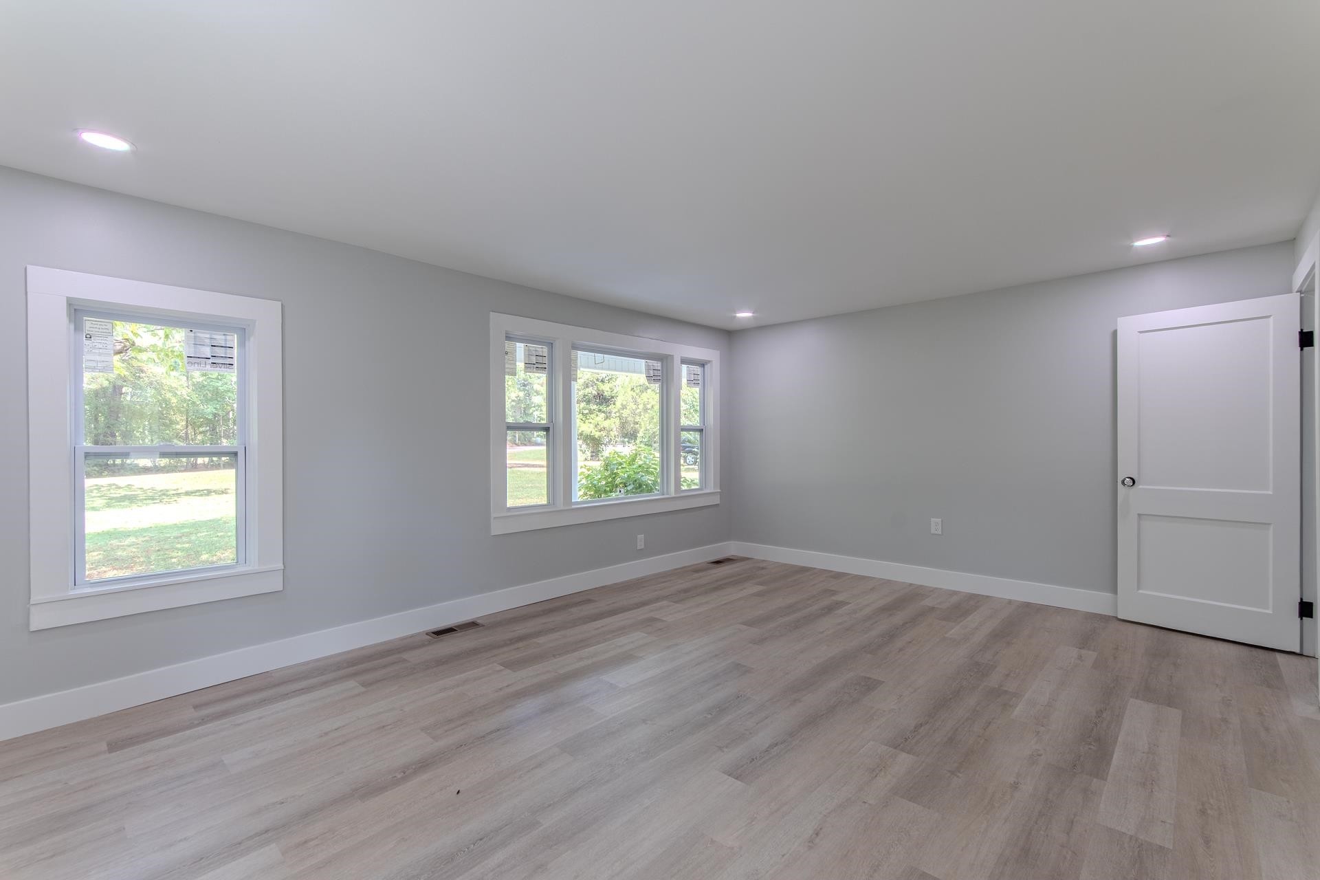 6800 Glendale Road Morris Chapel, TN 38361 - Photo 11 of 36 an empty room with wooden floor and windows