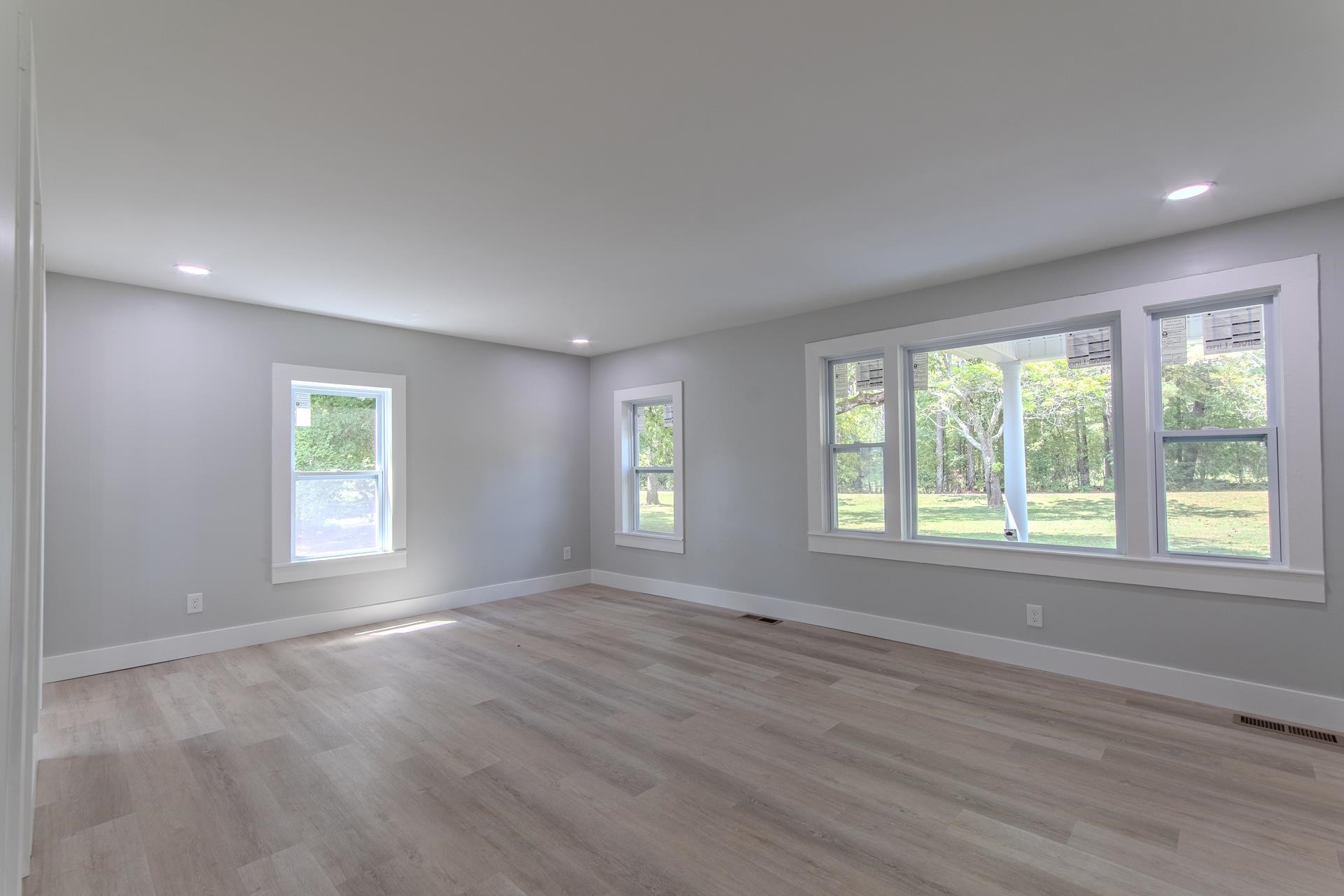 6800 Glendale Road Morris Chapel, TN 38361 - Photo 12 of 36 a view of an empty room with wooden floor and a window