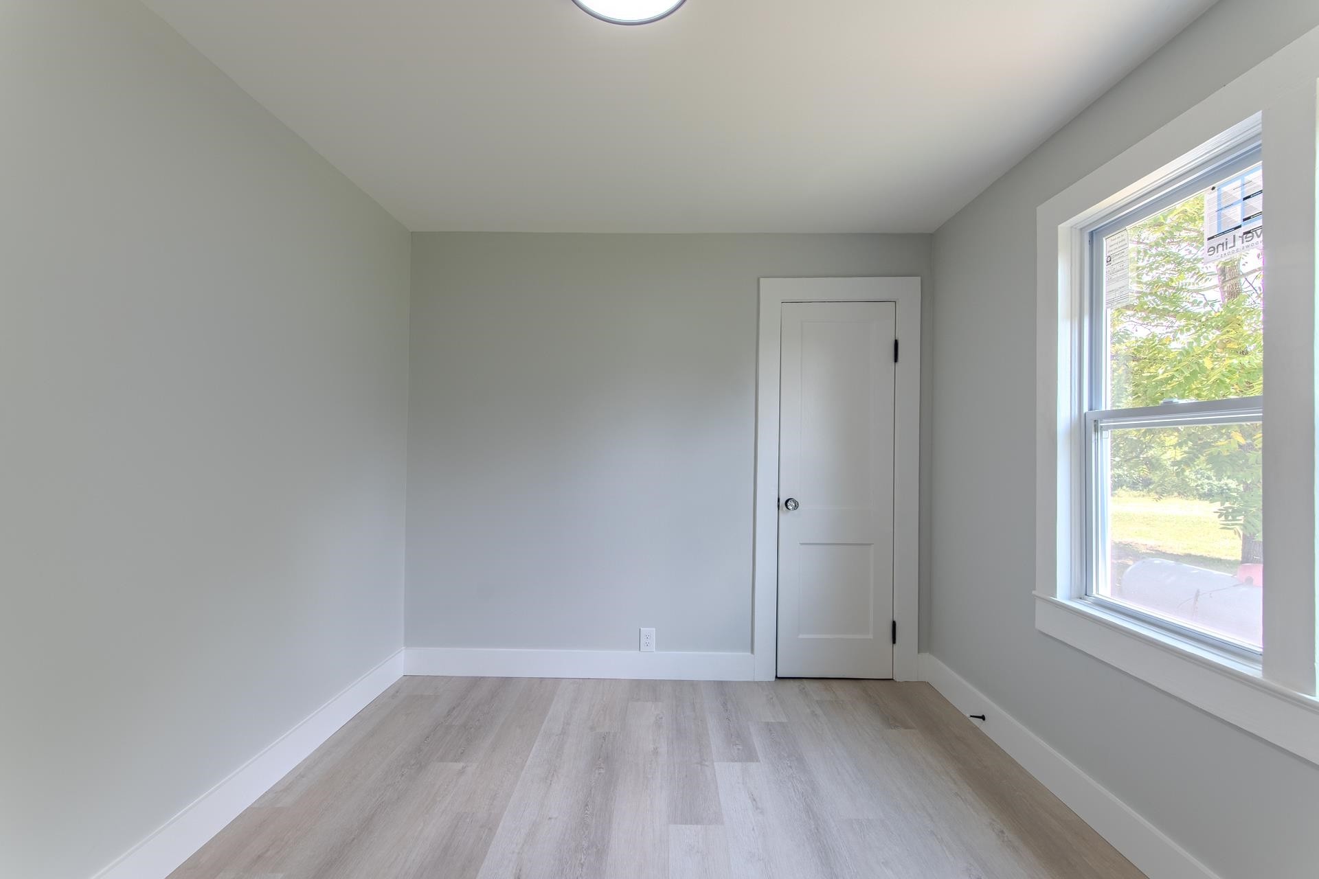 6800 Glendale Road Morris Chapel, TN 38361 - Photo 19 of 36 a view of an empty room with a window and wooden floor