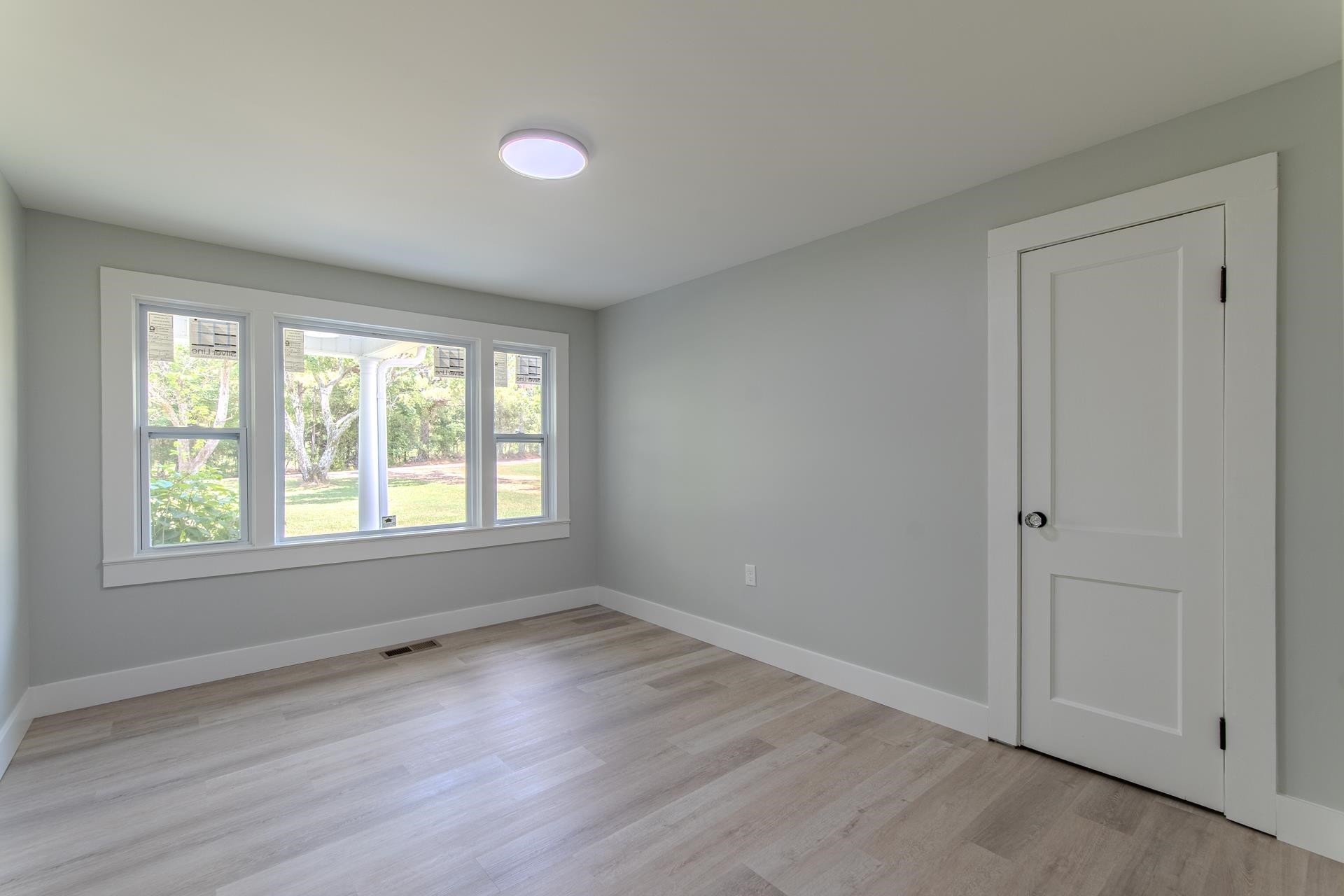 6800 Glendale Road Morris Chapel, TN 38361 - Photo 21 of 36 an empty room with wooden floor and windows
