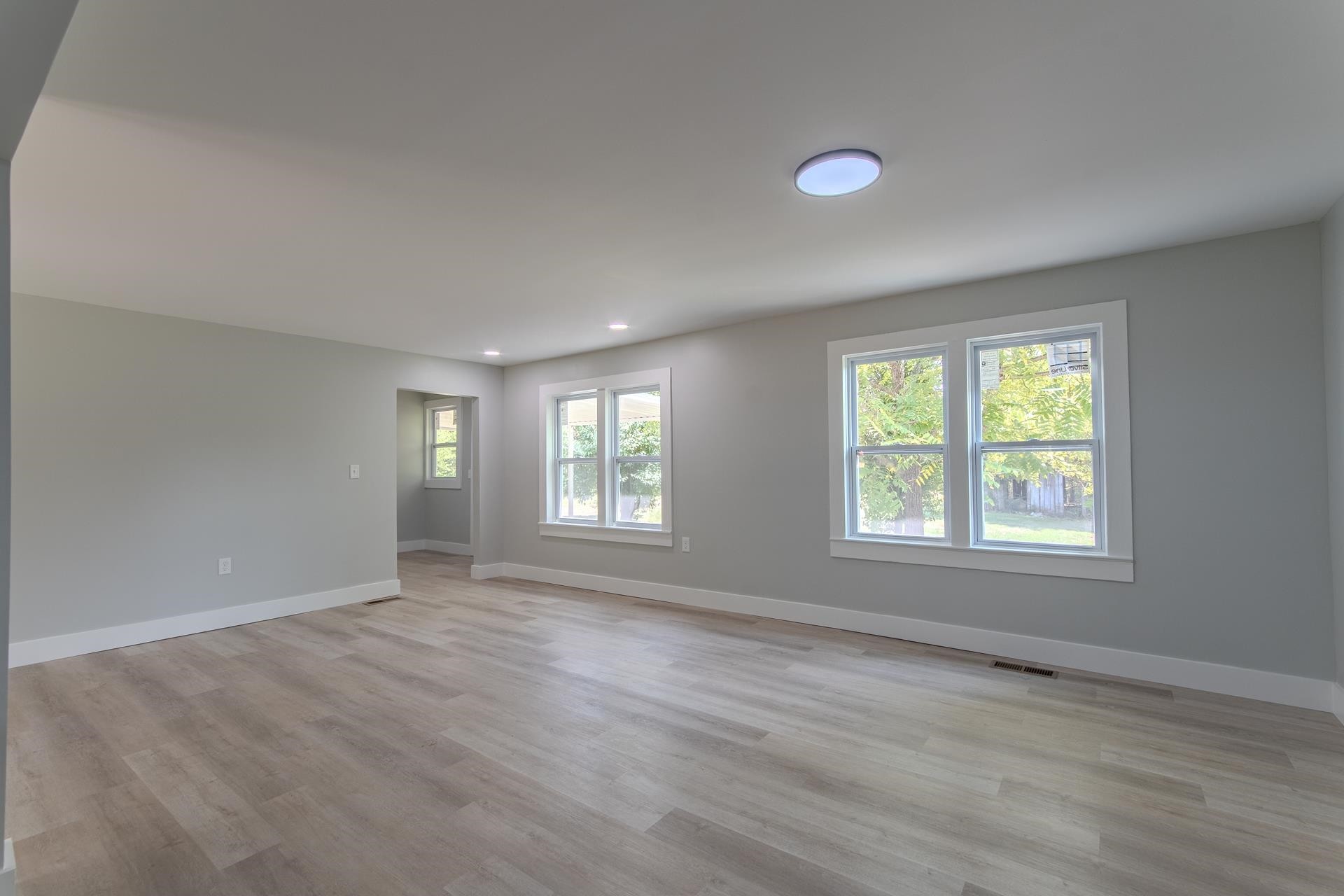 6800 Glendale Road Morris Chapel, TN 38361 - Photo 6 of 36 a view of an empty room with a window and wooden floor