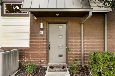 a front view of a house with plants