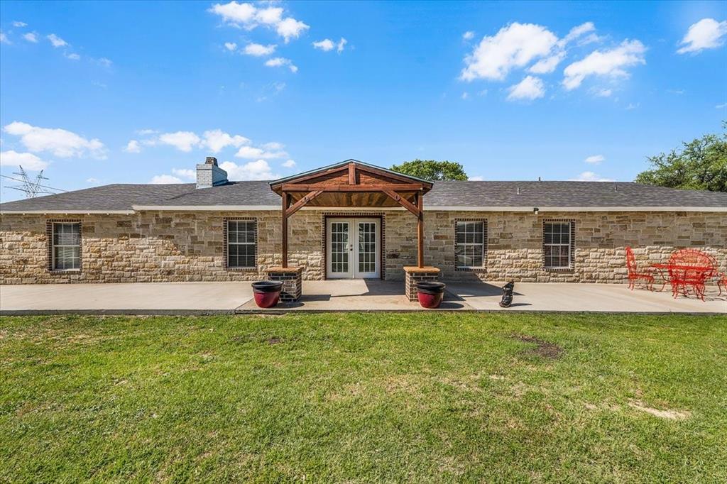 748 Rocky Ridge Lane Weatherford, TX 76085 - Photo 1 of 38 a view of a house with a garden and patio
