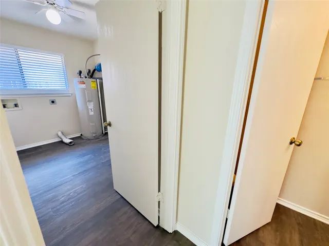 a view of entryway and hall with wooden floor