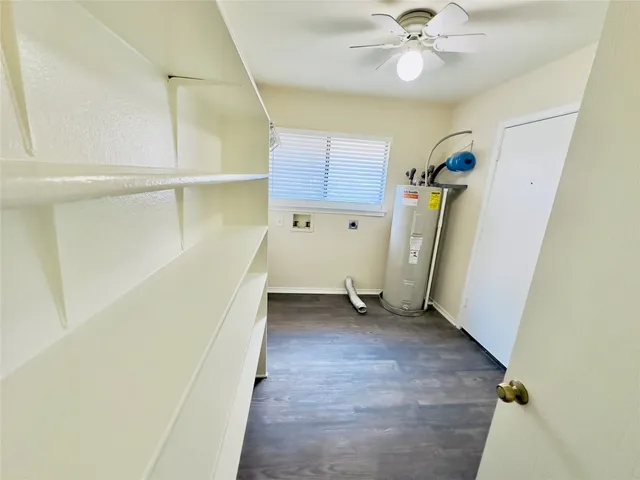 a white toilet sitting next to a white wall