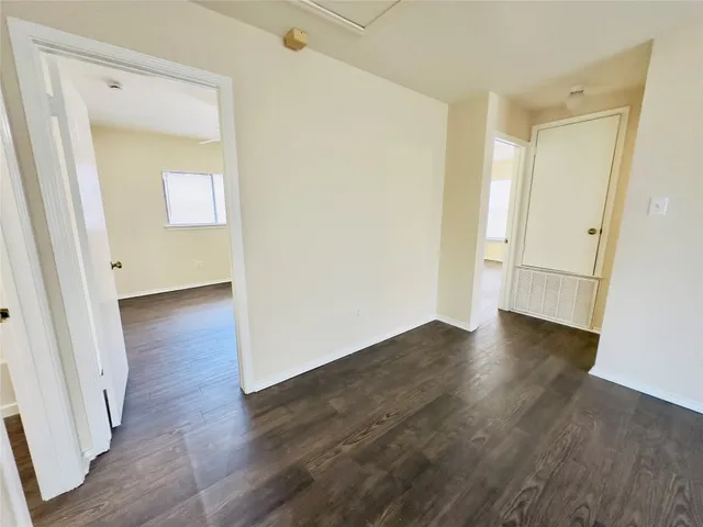 a view of a room with wooden floor