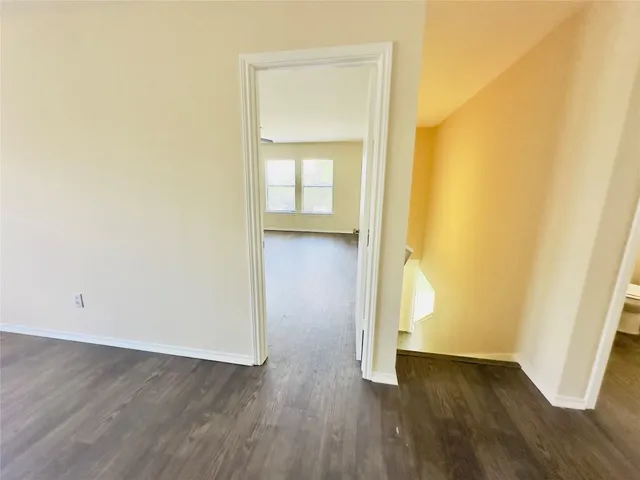 a view of a room with wooden floor and stairs
