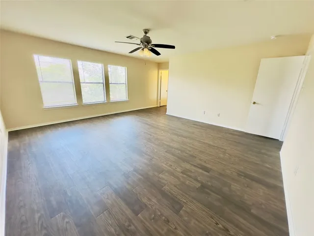 an empty room with wooden floor and closet