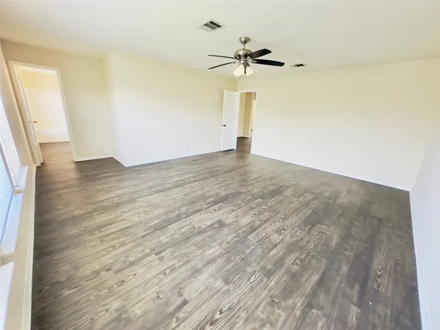 wooden floor in an empty room with a window