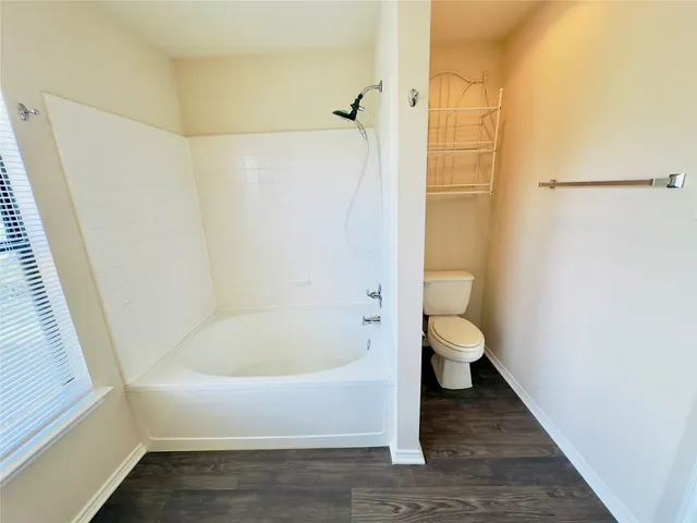 a bathroom with a tub sink and mirror