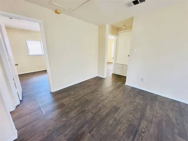 a view of walk in closet with wooden floor and window