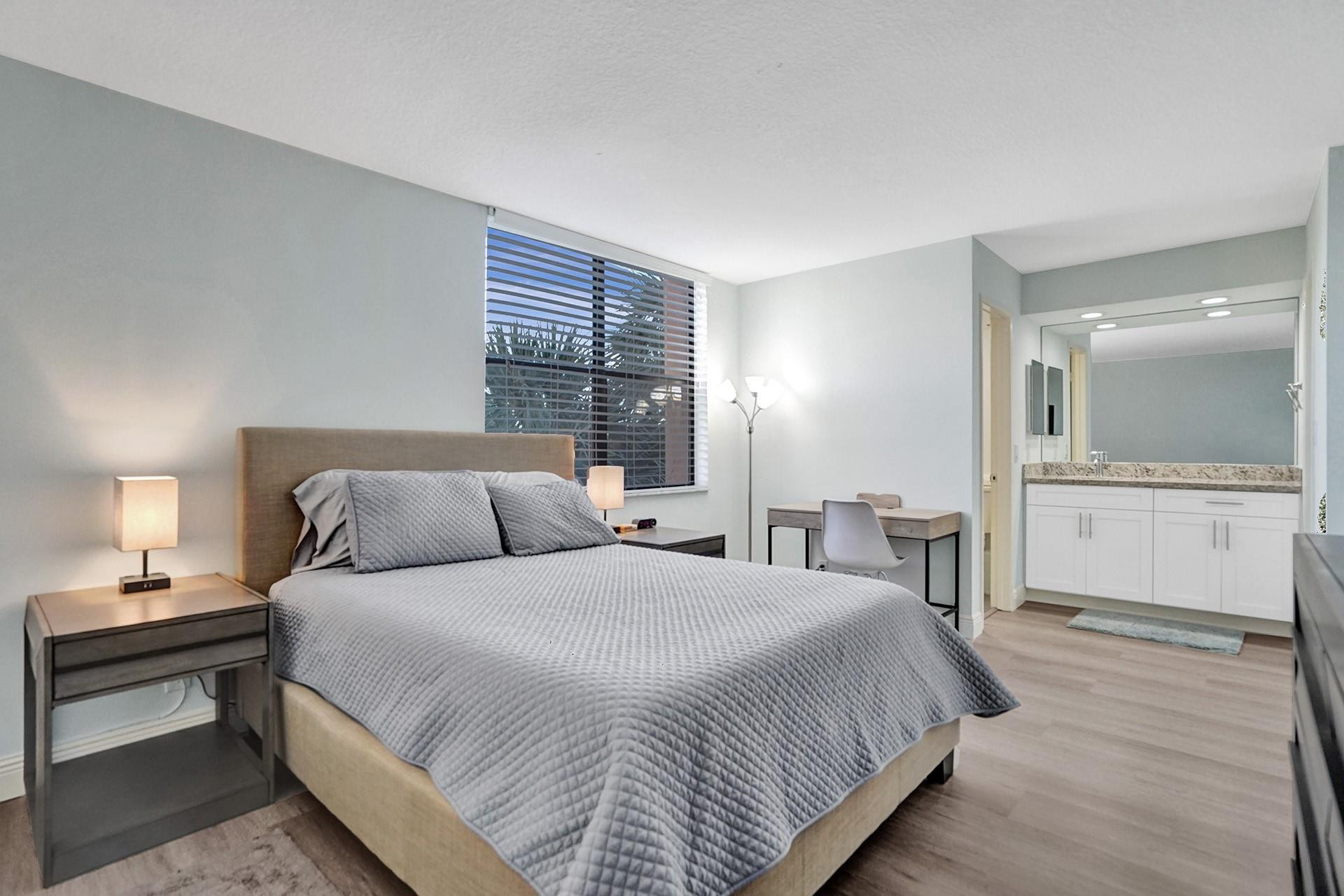 955 Dotterel Road, Unit 2304 Delray Beach, FL 33444 - Photo 16 of 47 a bedroom with double bed and a night stand