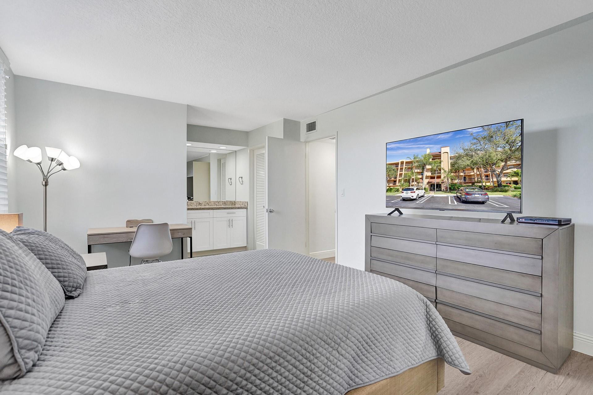 955 Dotterel Road, Unit 2304 Delray Beach, FL 33444 - Photo 17 of 47 a bedroom with a bed and a dresser