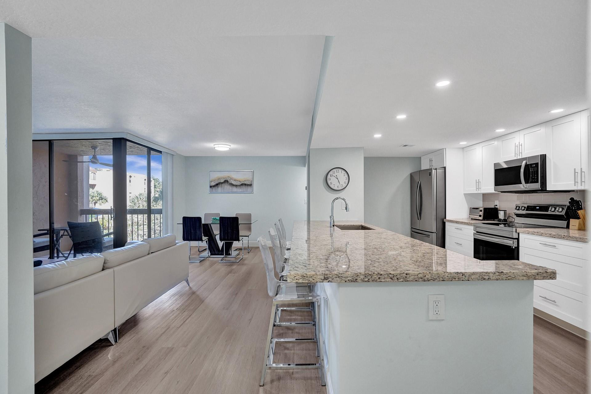955 Dotterel Road, Unit 2304 Delray Beach, FL 33444 - Photo 21 of 47 a view of living room kitchen with stainless steel appliances granite countertop living room
