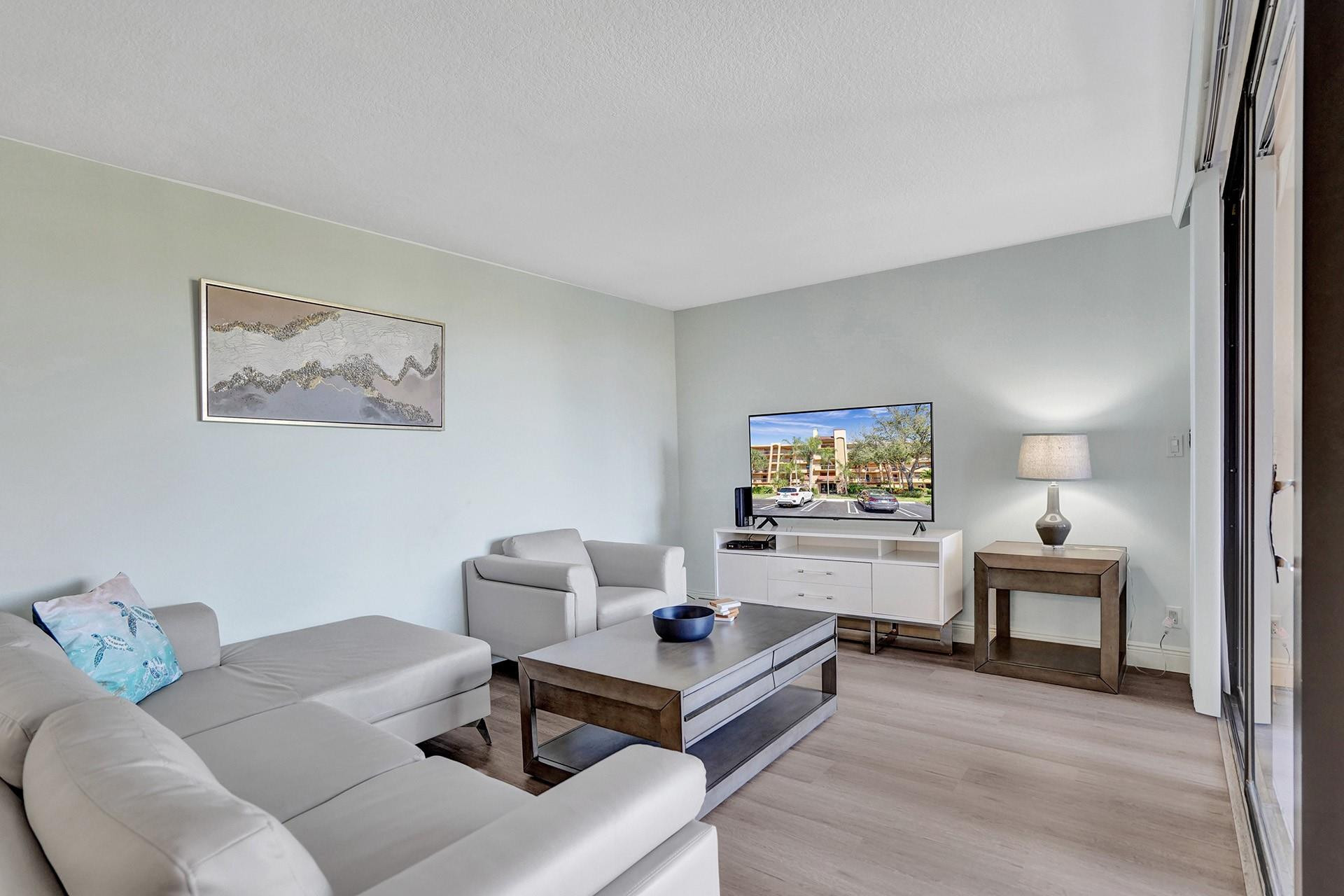 955 Dotterel Road, Unit 2304 Delray Beach, FL 33444 - Photo 24 of 47 a living room with furniture and a painting on the wall