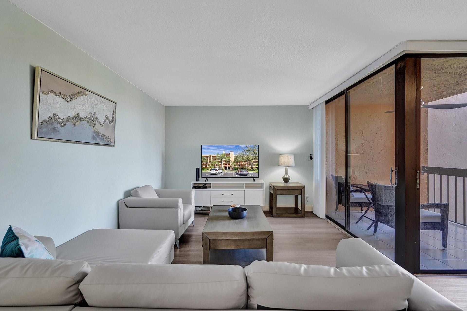 955 Dotterel Road, Unit 2304 Delray Beach, FL 33444 - Photo 3 of 47 a living room with furniture and a flat screen tv