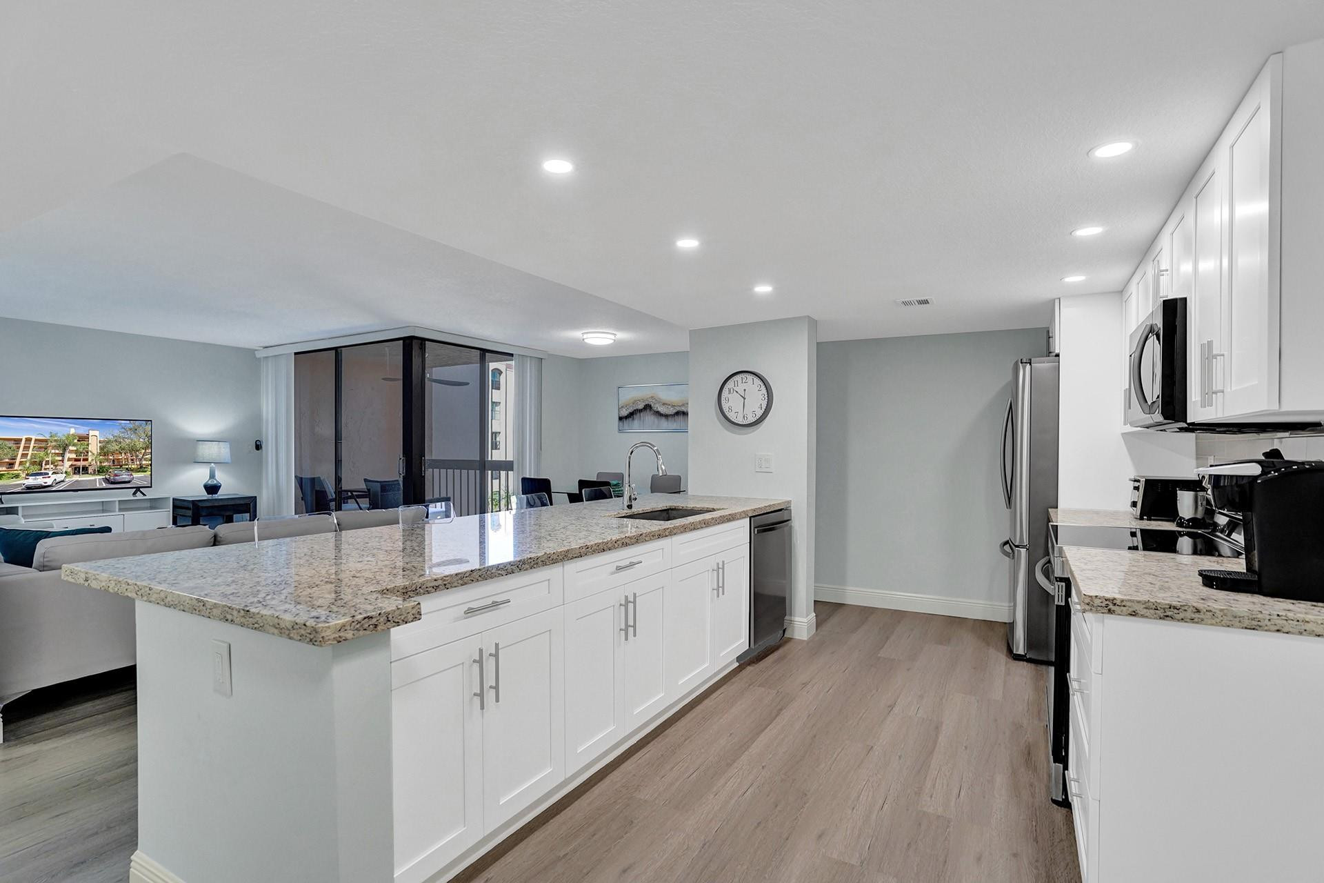 955 Dotterel Road, Unit 2304 Delray Beach, FL 33444 - Photo 32 of 47 a large kitchen with kitchen island a sink a center island stainless steel appliances and a counter space