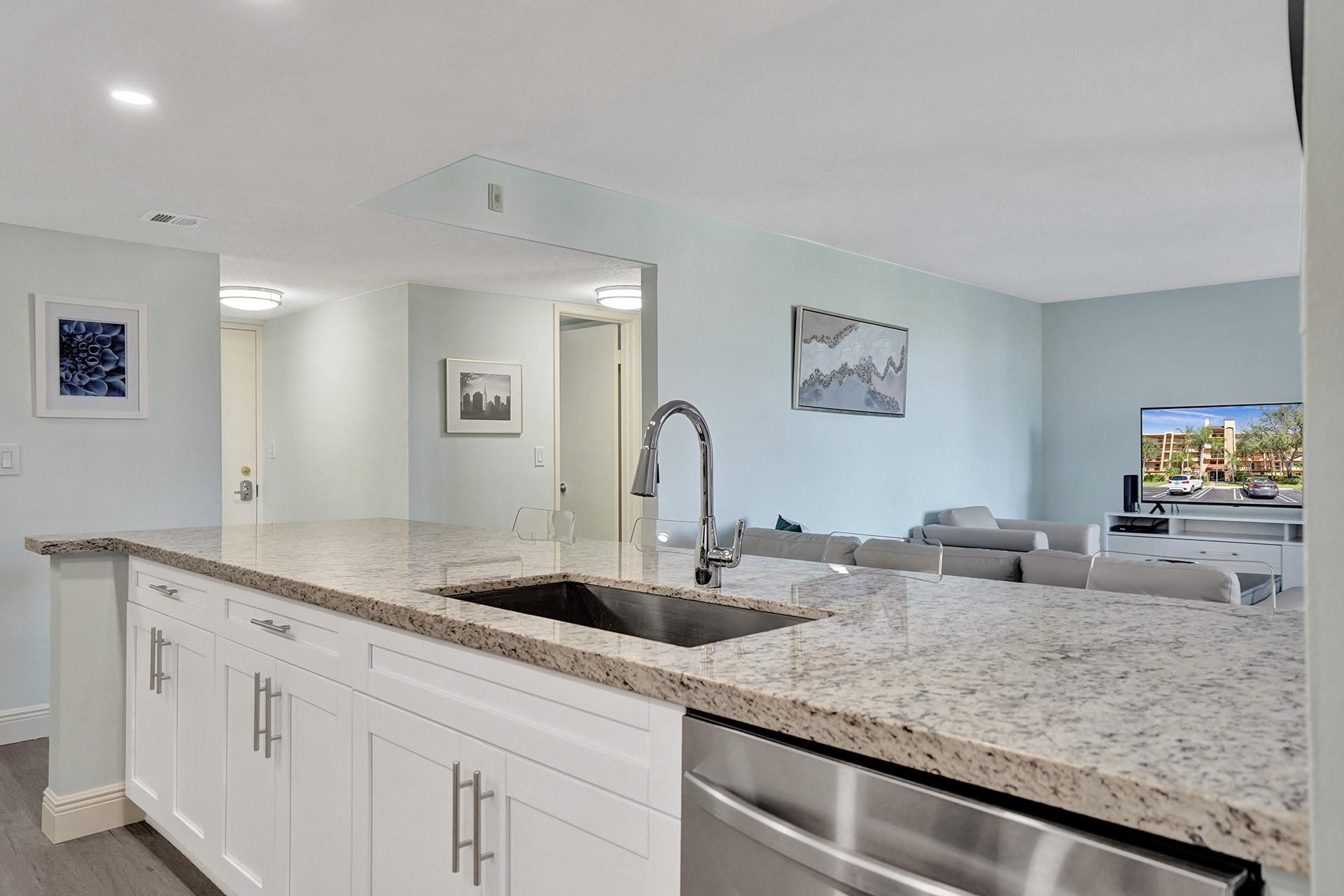 955 Dotterel Road, Unit 2304 Delray Beach, FL 33444 - Photo 36 of 47 a kitchen with sink and mirror