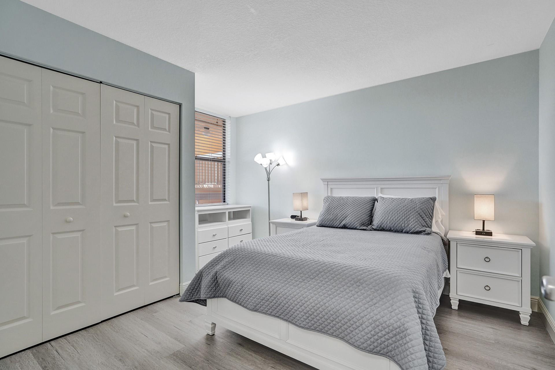 955 Dotterel Road, Unit 2304 Delray Beach, FL 33444 - Photo 6 of 47 a bedroom with a bed and a night stand
