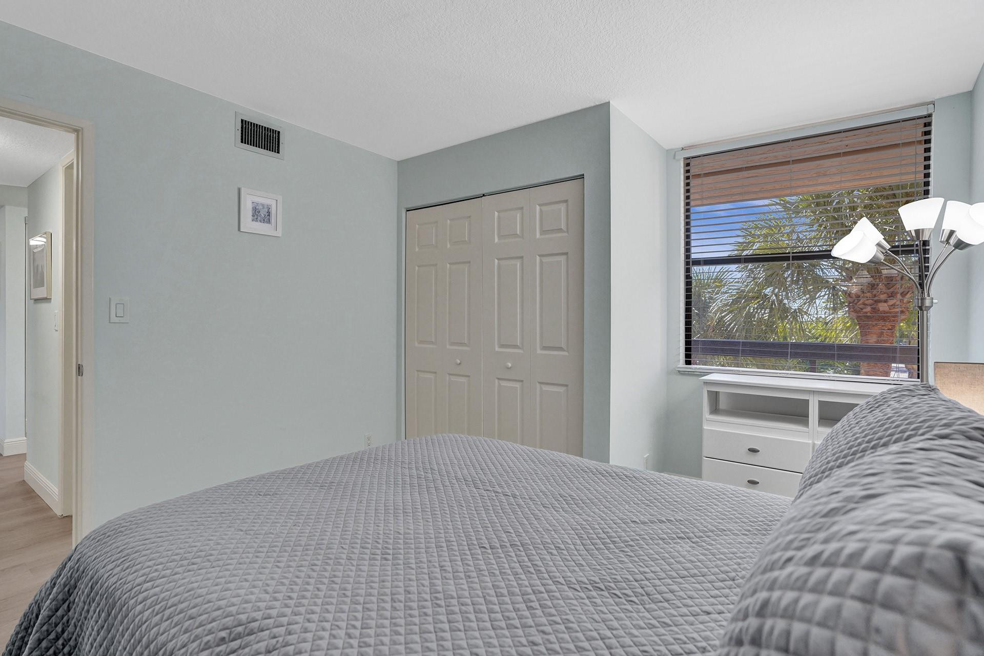 955 Dotterel Road, Unit 2304 Delray Beach, FL 33444 - Photo 8 of 47 a bedroom with a bed and a view of kitchen