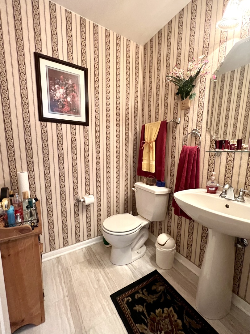 1800 Fulton Lane Sycamore, IL 60178 - Photo 12 of 48 a bathroom with a toilet a sink and a shower curtain