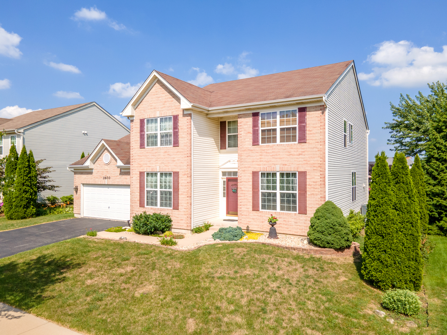 1800 Fulton Lane Sycamore, IL 60178 - Photo 2 of 48 a front view of a house with a yard and garage