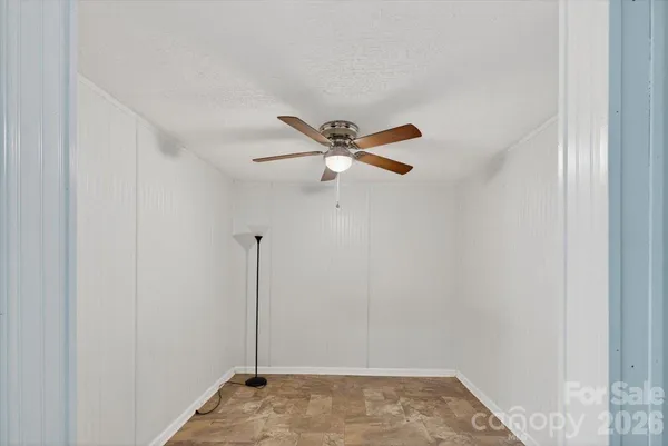 a view of a hallway with a ceiling fan