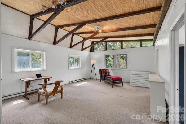 a bedroom with furniture and a window