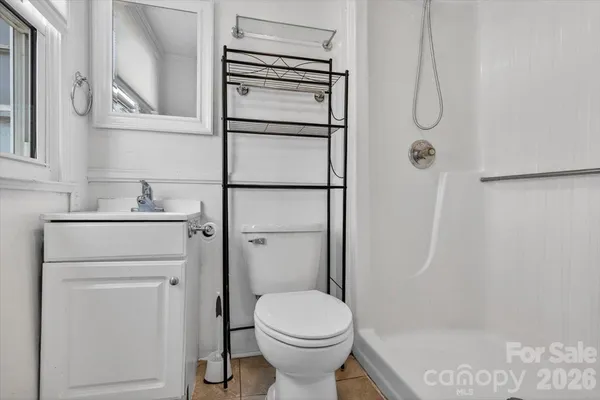 a bathroom with a shower a toilet and a sink