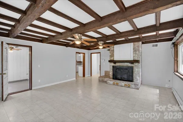 a view of an empty room with a fireplace