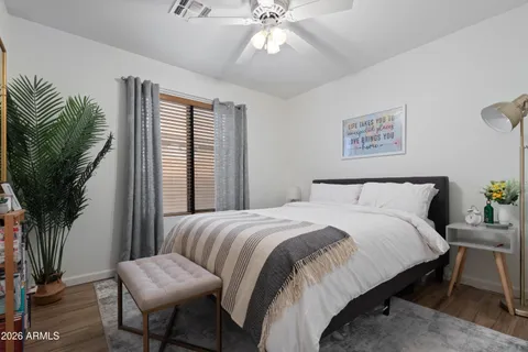 a bedroom with a large bed and a chandelier