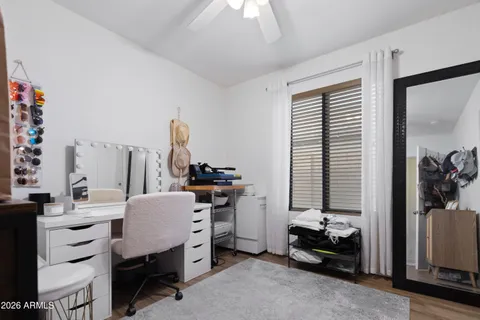 a view of a workspace with furniture and a window