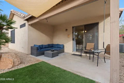 a view of a house with backyard and sitting area