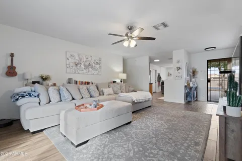 a living room with furniture and a chandelier