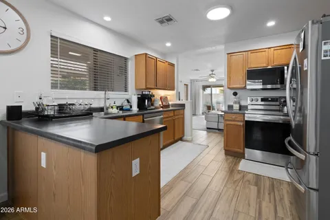 a kitchen with stainless steel appliances a sink stove and cabinets